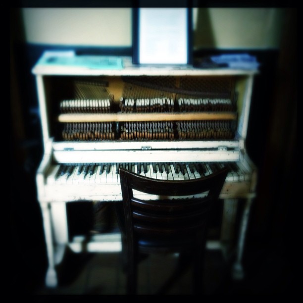 an old piano in the dark of day
