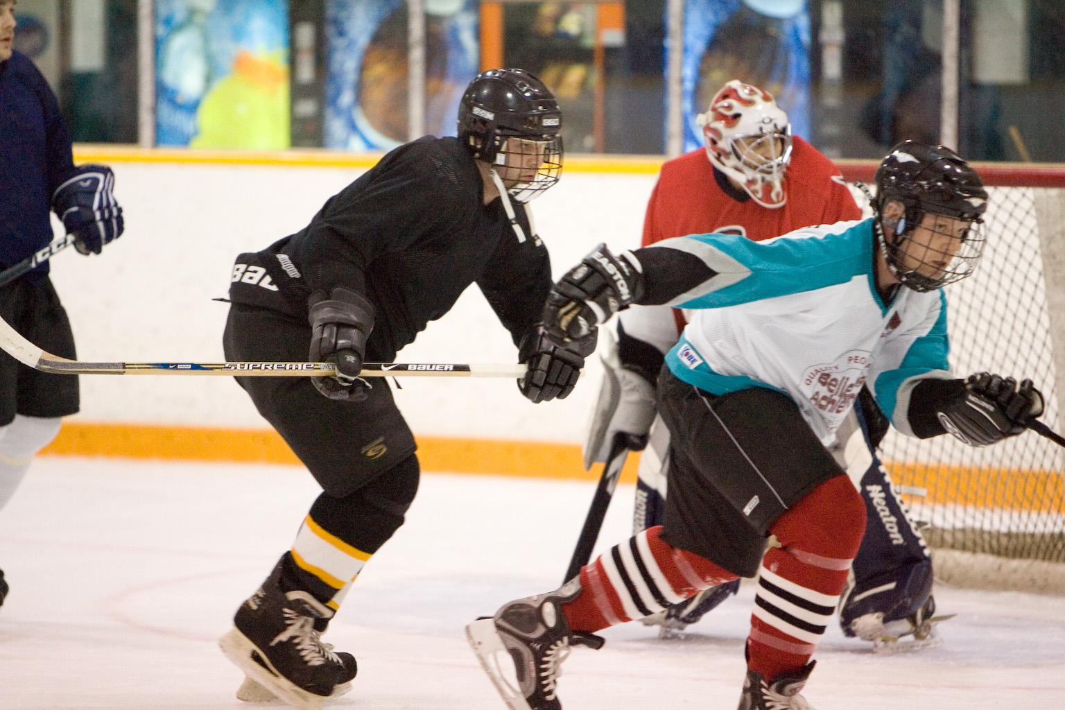 a group of people playing a game of ice hockey