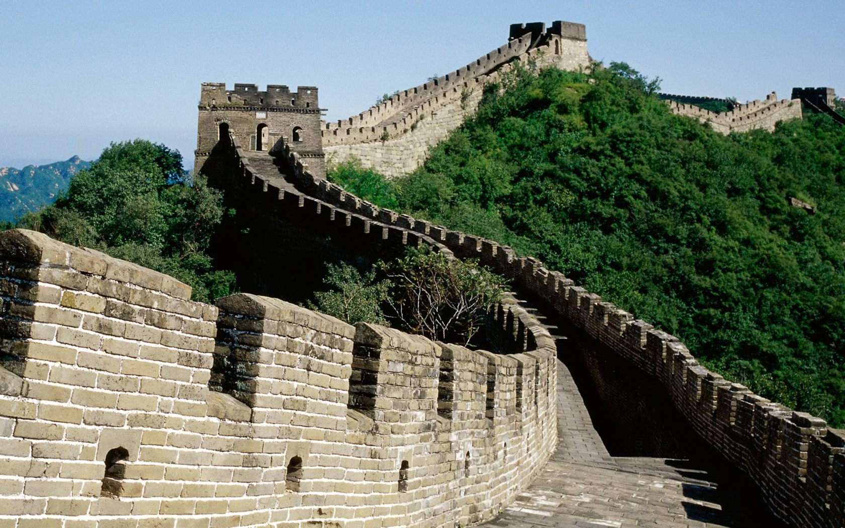 a very old stone walkway on a mountain with lots of hills