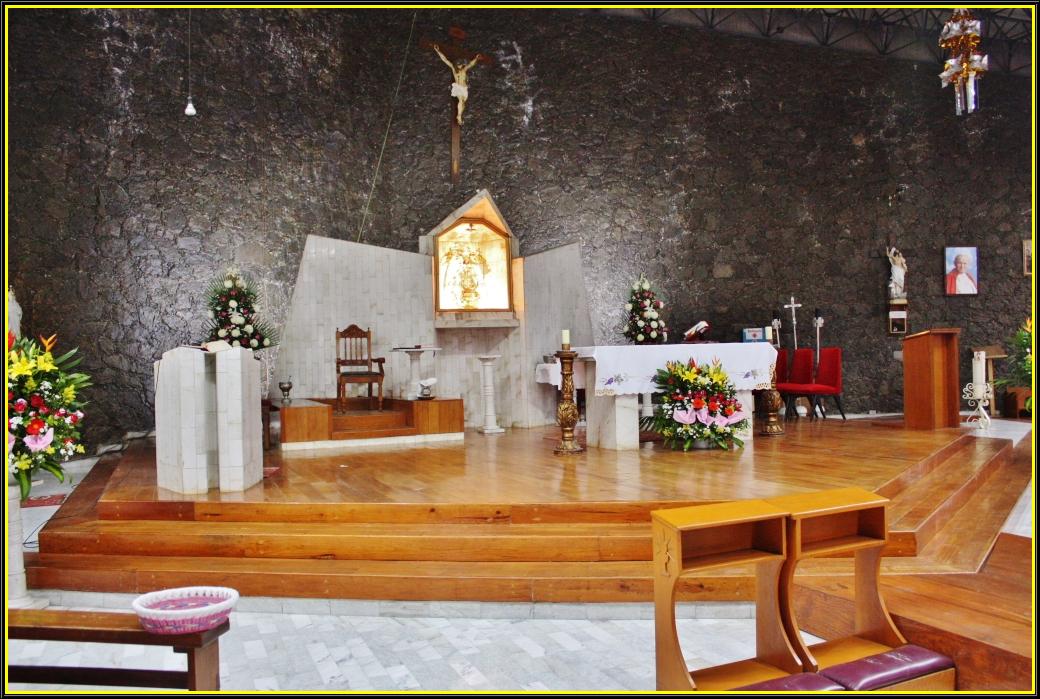 the inside of a church with wood pews