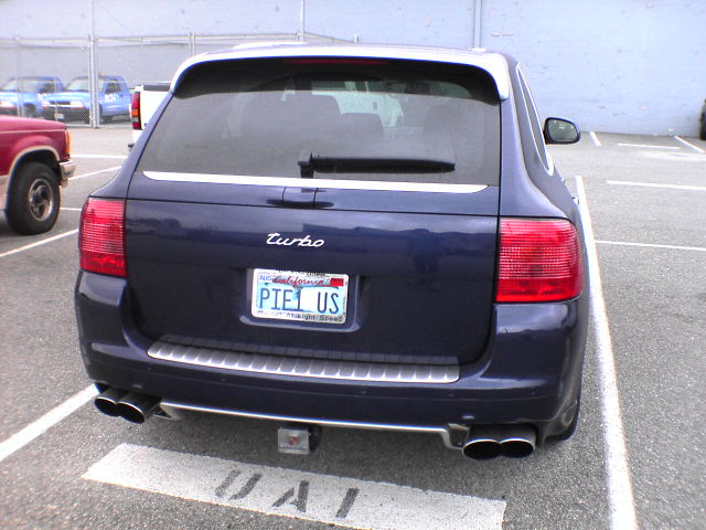 a car parked in a lot with a license plate