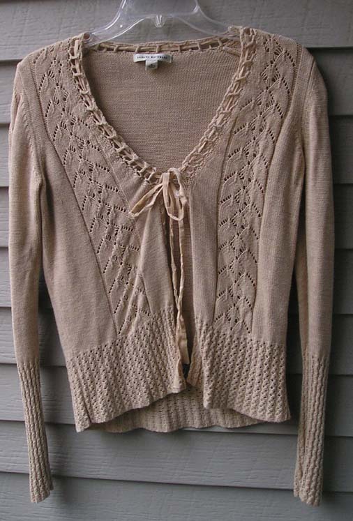 an adorable cardigan sweater is hanging outside
