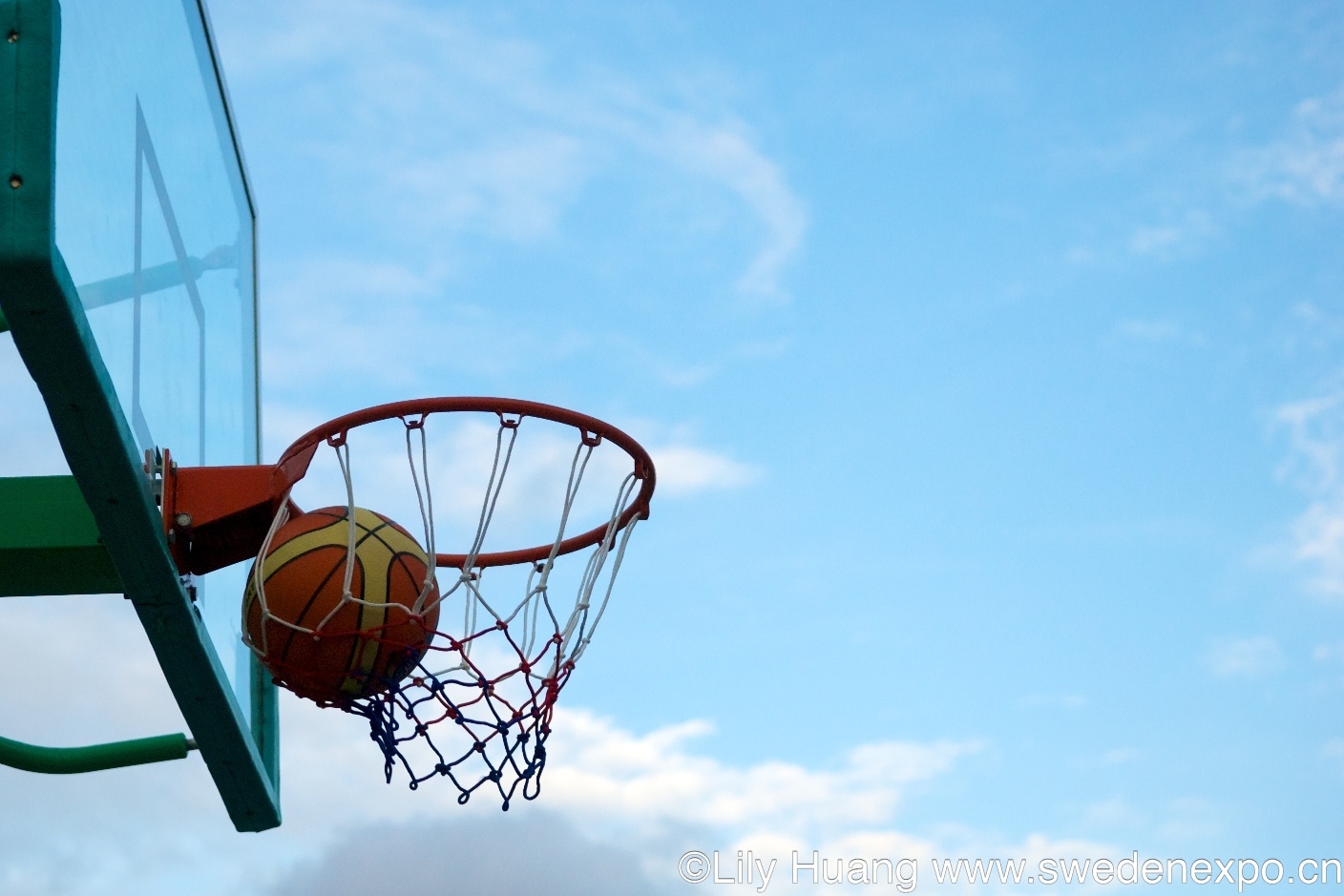 a basketball hoop is seen on a sunny day