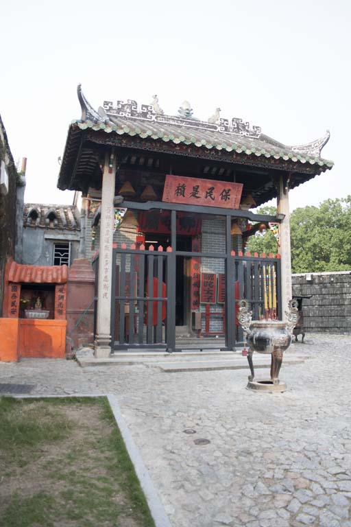 a chinese style building with red doors on the front