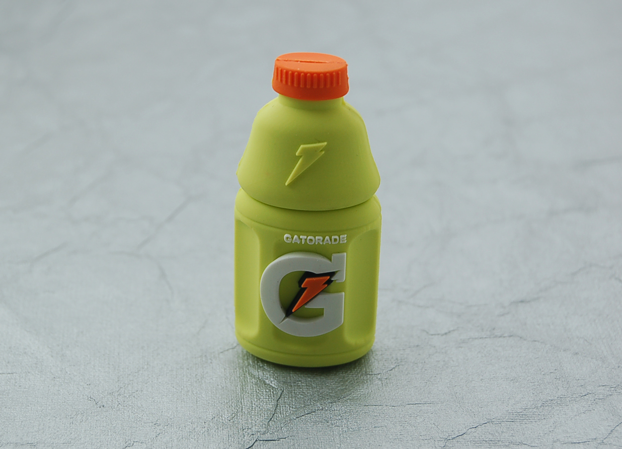 a neon green bottle with an orange cap