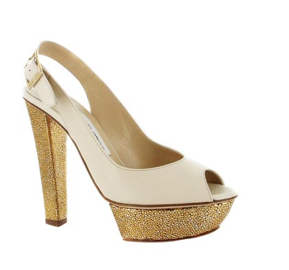 white high heeled shoe with golden glitters on the bottom