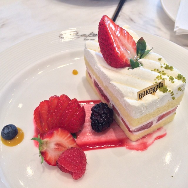 a piece of strawberry cake on top of a white plate