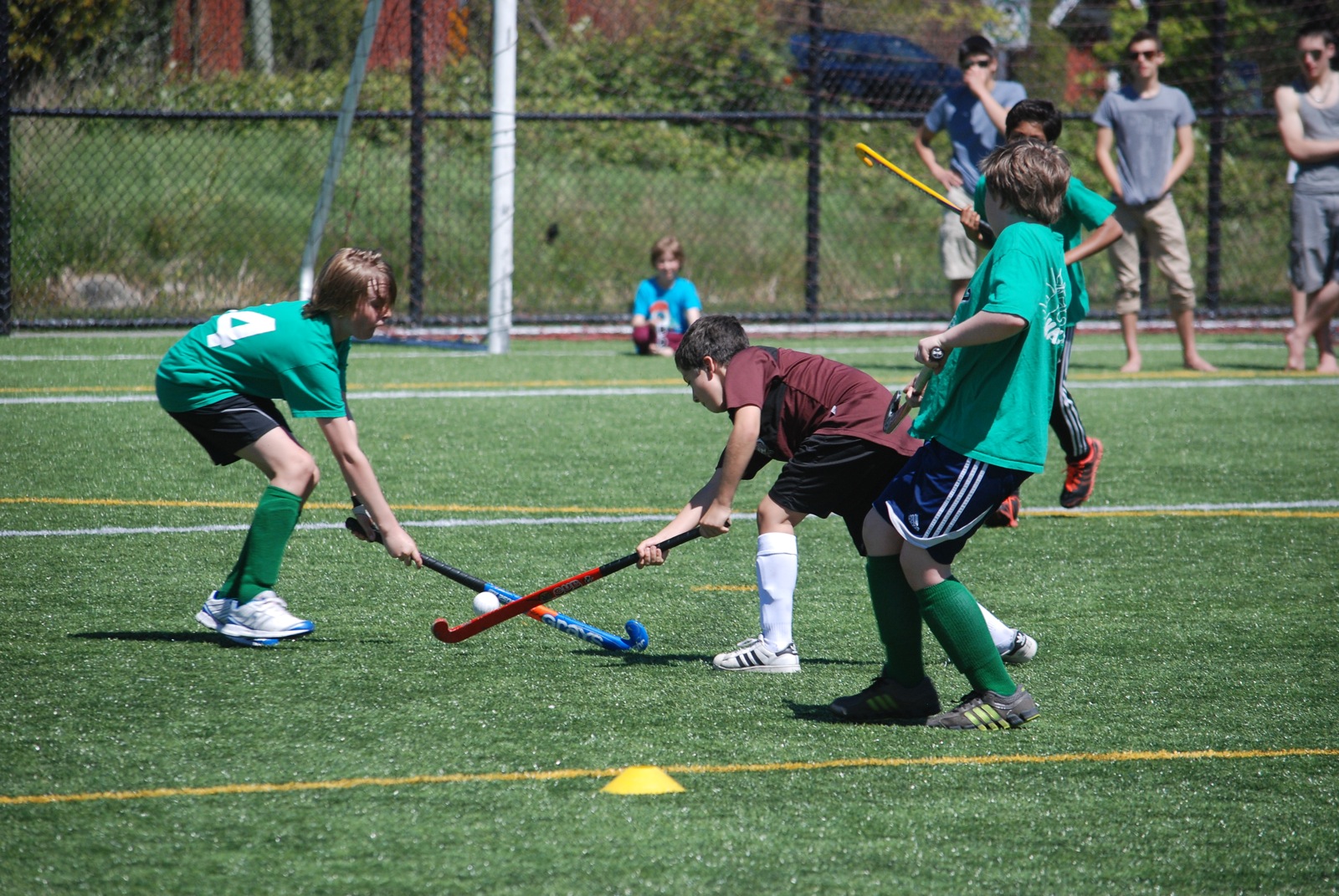 the group of children are playing in a lacrosse game