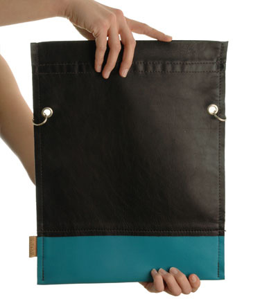 a person is holding a big piece of black and blue leather