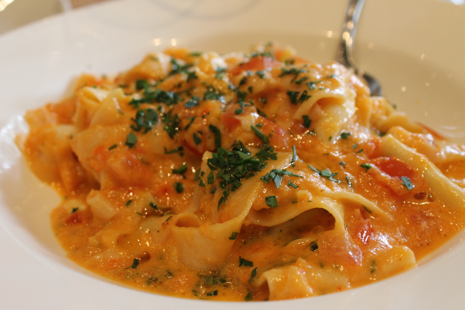 closeup s of some pasta in a white bowl