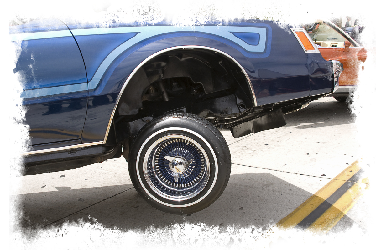 a blue pick up truck with some big wheels
