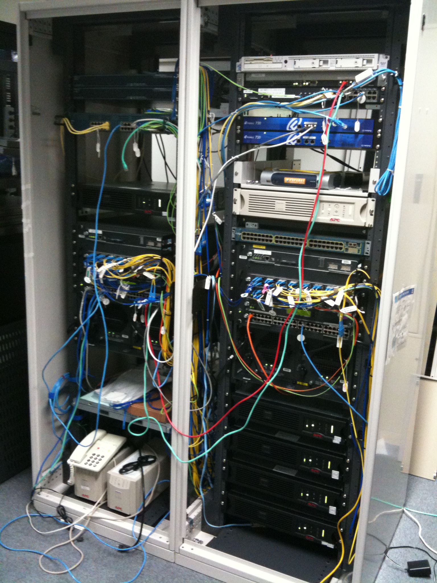 a bunch of wires are connected to the sides of servers