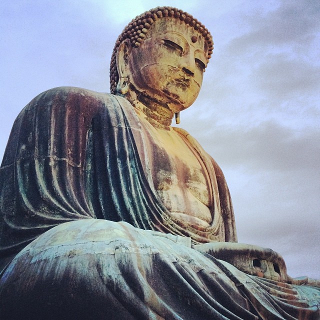 the big buddha statue is surrounded by many rocks