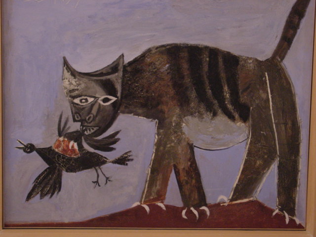a painting of a cat and a bird by a wall