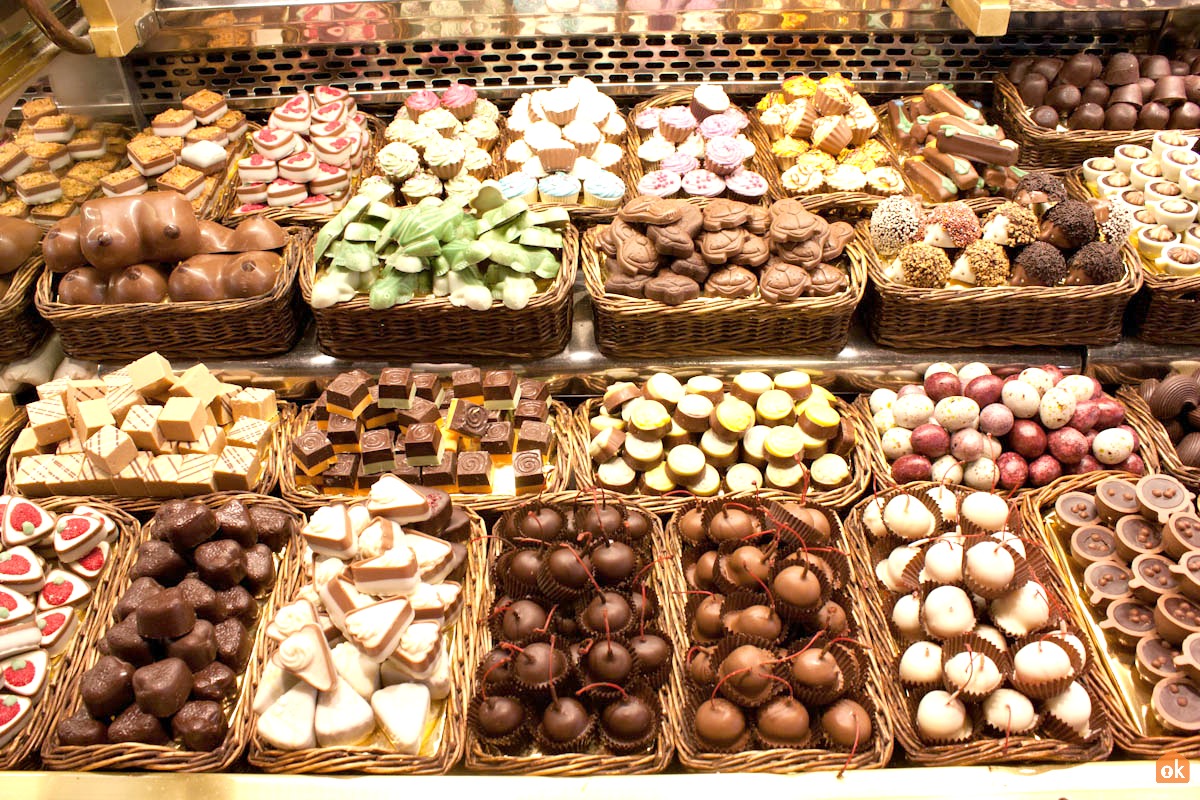 assorted chocolates, pastries, and cakes displayed in baskets