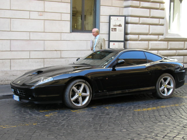 a car parked on the side of the road next to a building