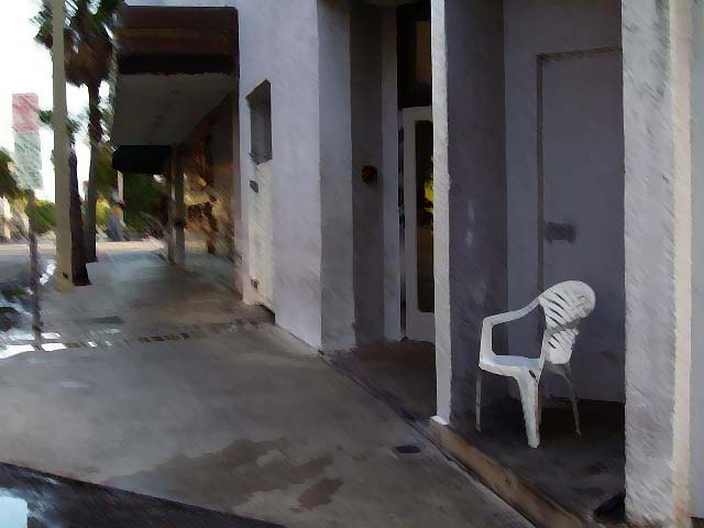 a white chair sits by a closed door