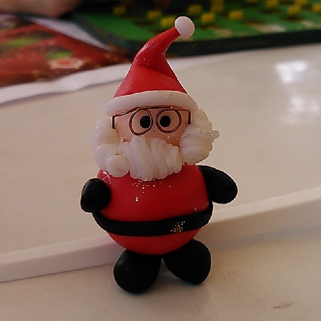 a red santa toy with glasses and a beard