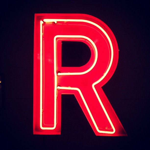 a red neon letter that is lit up