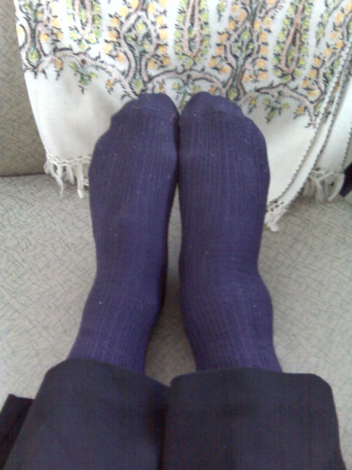 a person's feet in blue socks and stockings