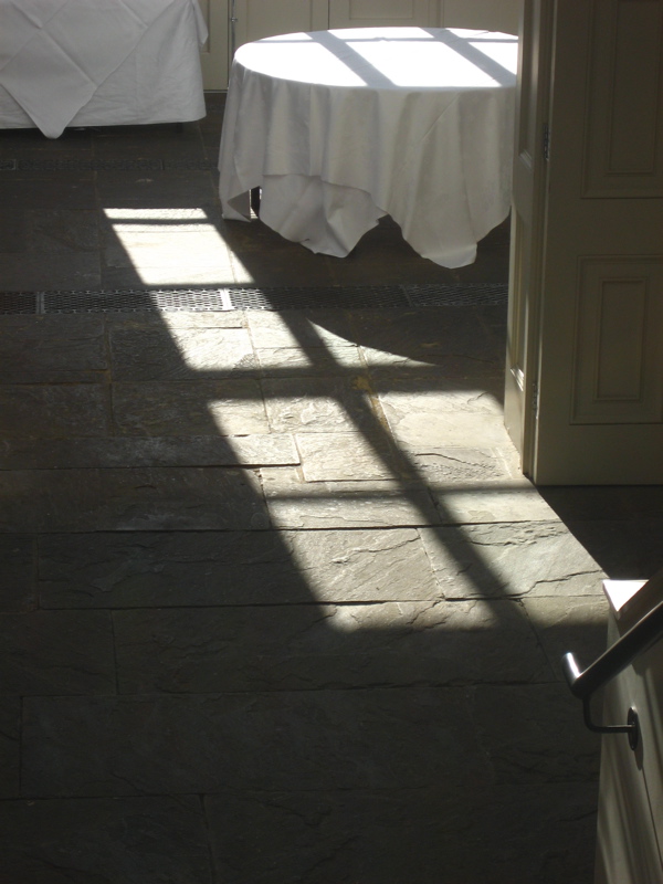 a bedroom with sun reflecting on the floor