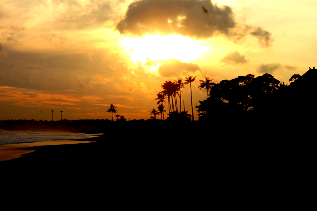 a bright orange sky above the ocean