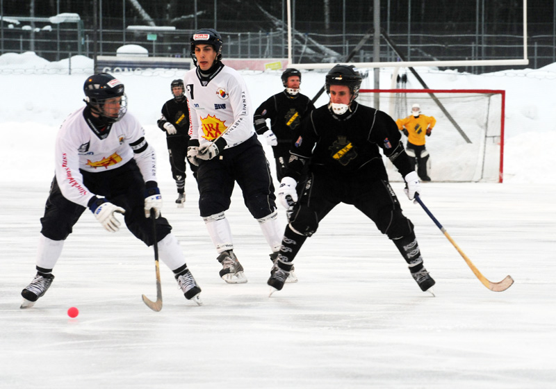 an ice hockey game on the ice with players in motion