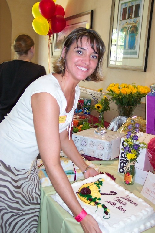 a smiling woman  a cake at a celetion