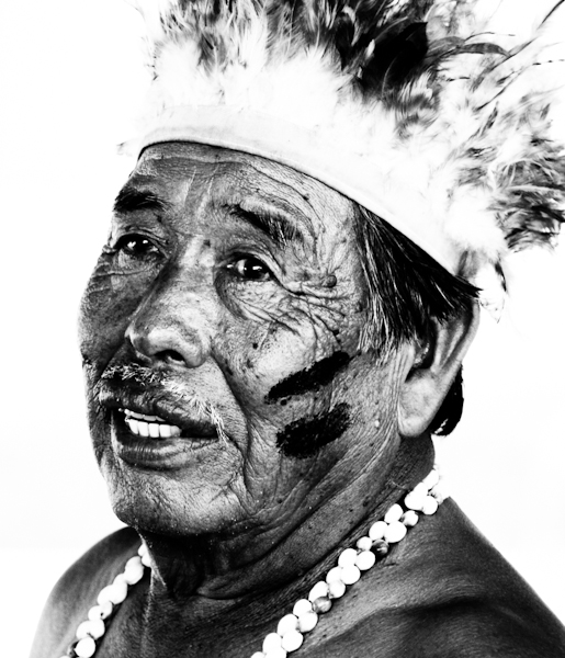 the black and white po shows an old man with a feathered headdress