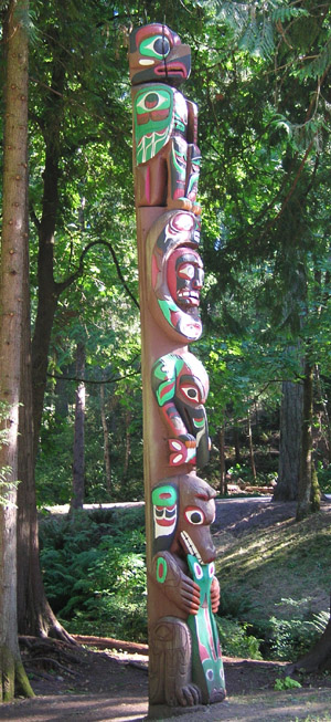 a tall, ornate totem pole with multiple faces on it