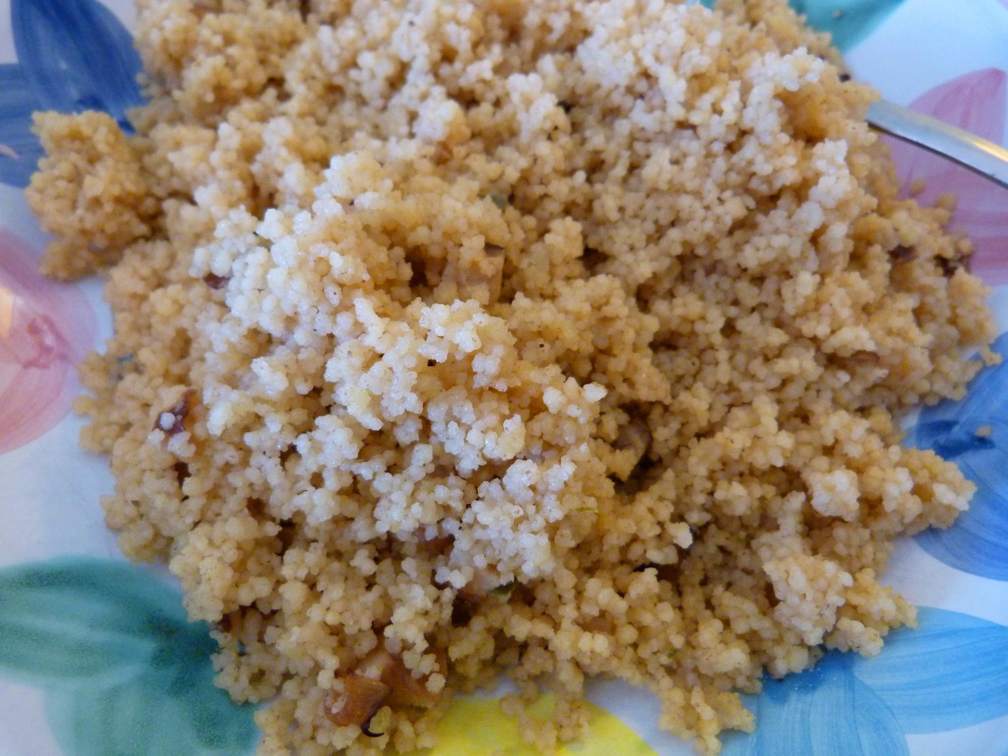 rice on a colorful plate with a candle next to it