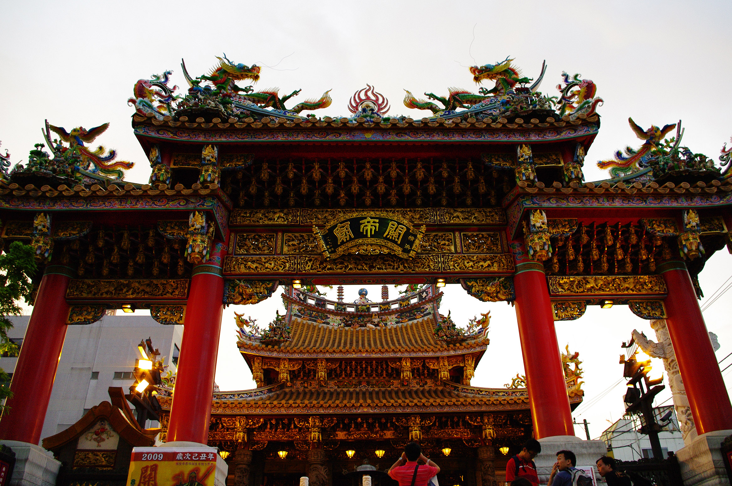 an archway with decorative artwork and a red structure