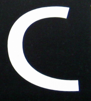a po of the letter c as the sun begins to rise over it