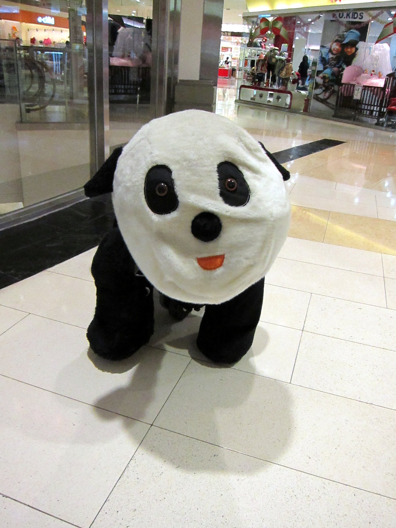 a black and white panda bear wearing a santa hat