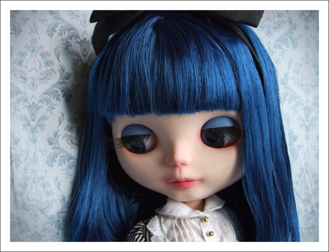 blue hair and a black bow around her head