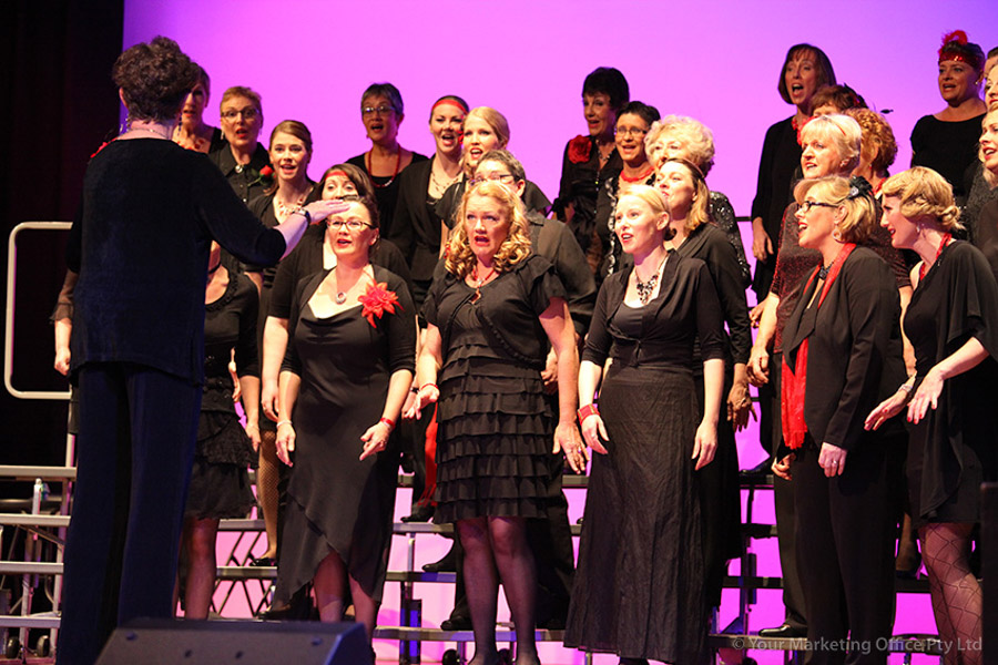 group of people singing with people clapping their hands