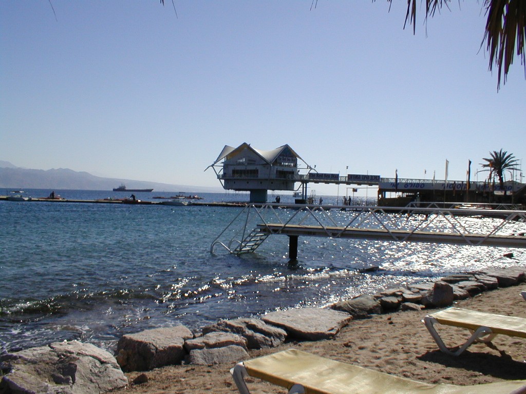 the shore line of a marina where the waves are hitting