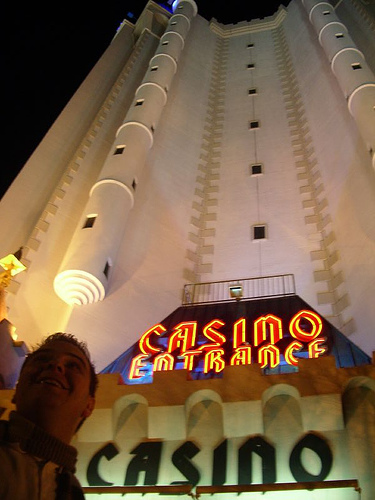 a casino entrance with a guy in front of it