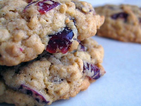 several cookies with cranberries stacked on top of each other