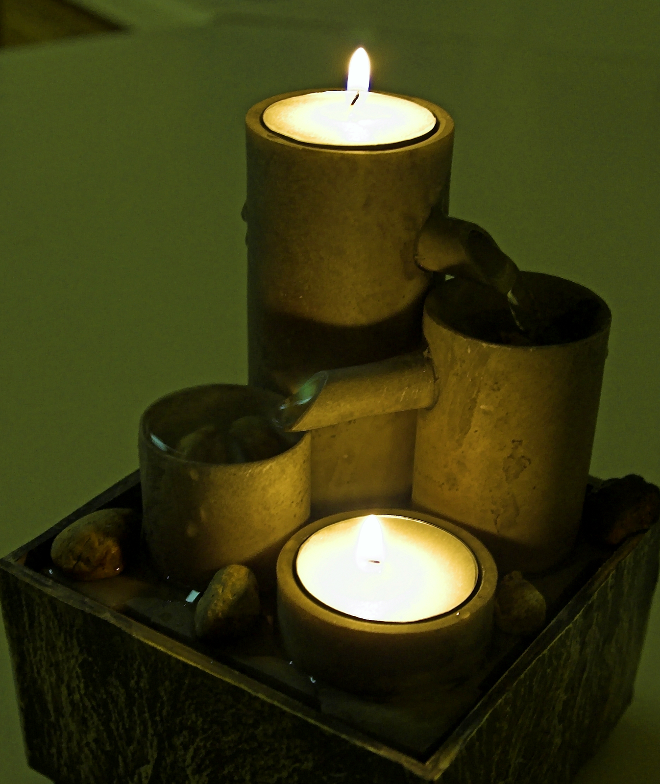 a small pot sits with some candles inside