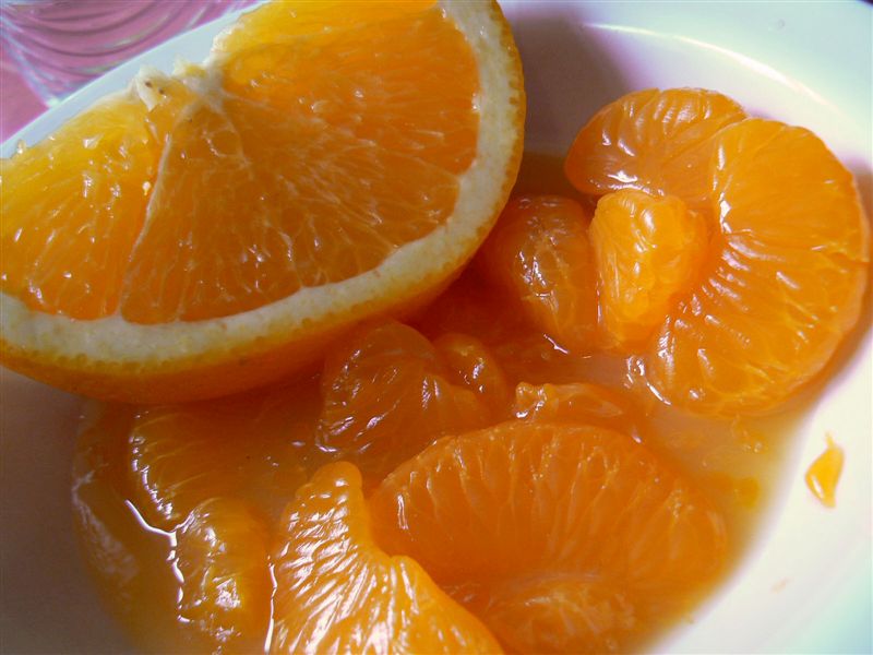 orange slices and water in a white bowl