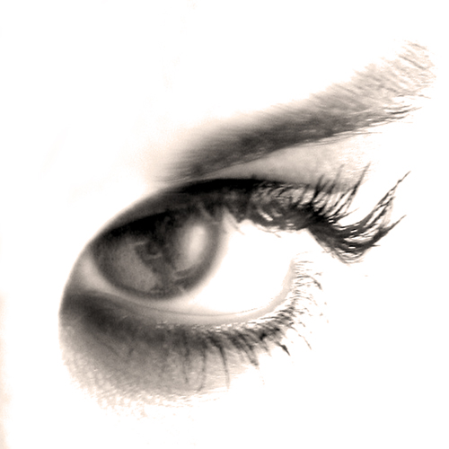 a womans eye with black and white image of a person