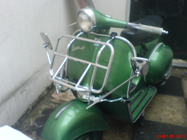 an old model green moped that is green
