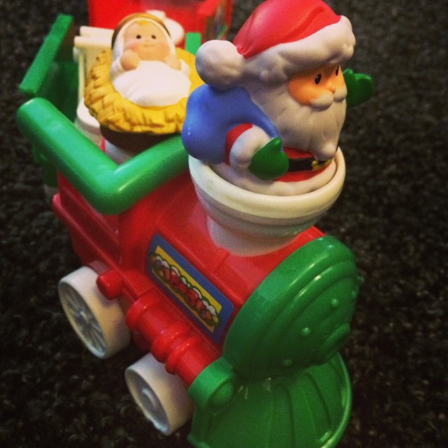 a santa clause riding on the front of a firetruck