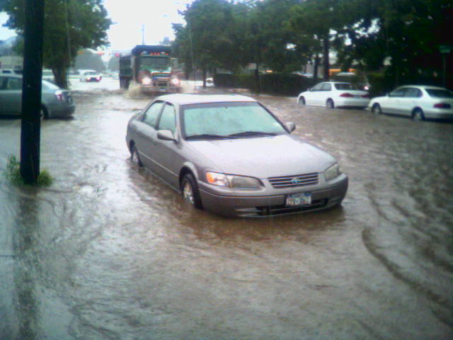 a car parked in flood water on the street