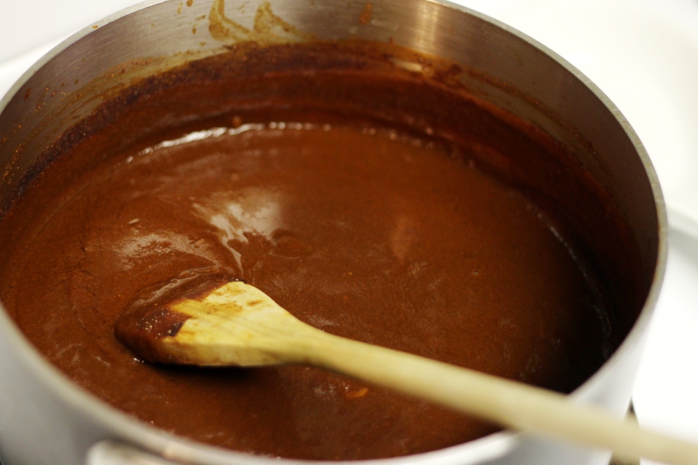 chocolate ding with spoon being stirred in the middle