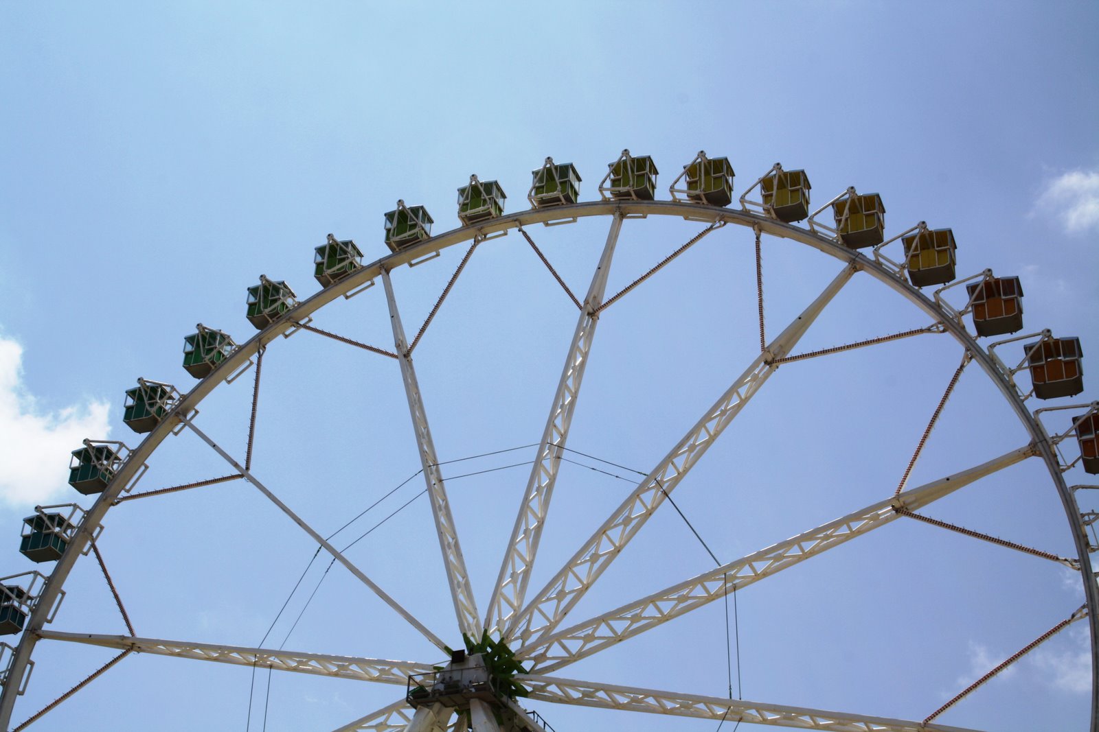 a big wheel in an amut park is going up in the sky