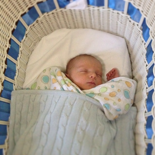 a little baby that is sleeping in a basket