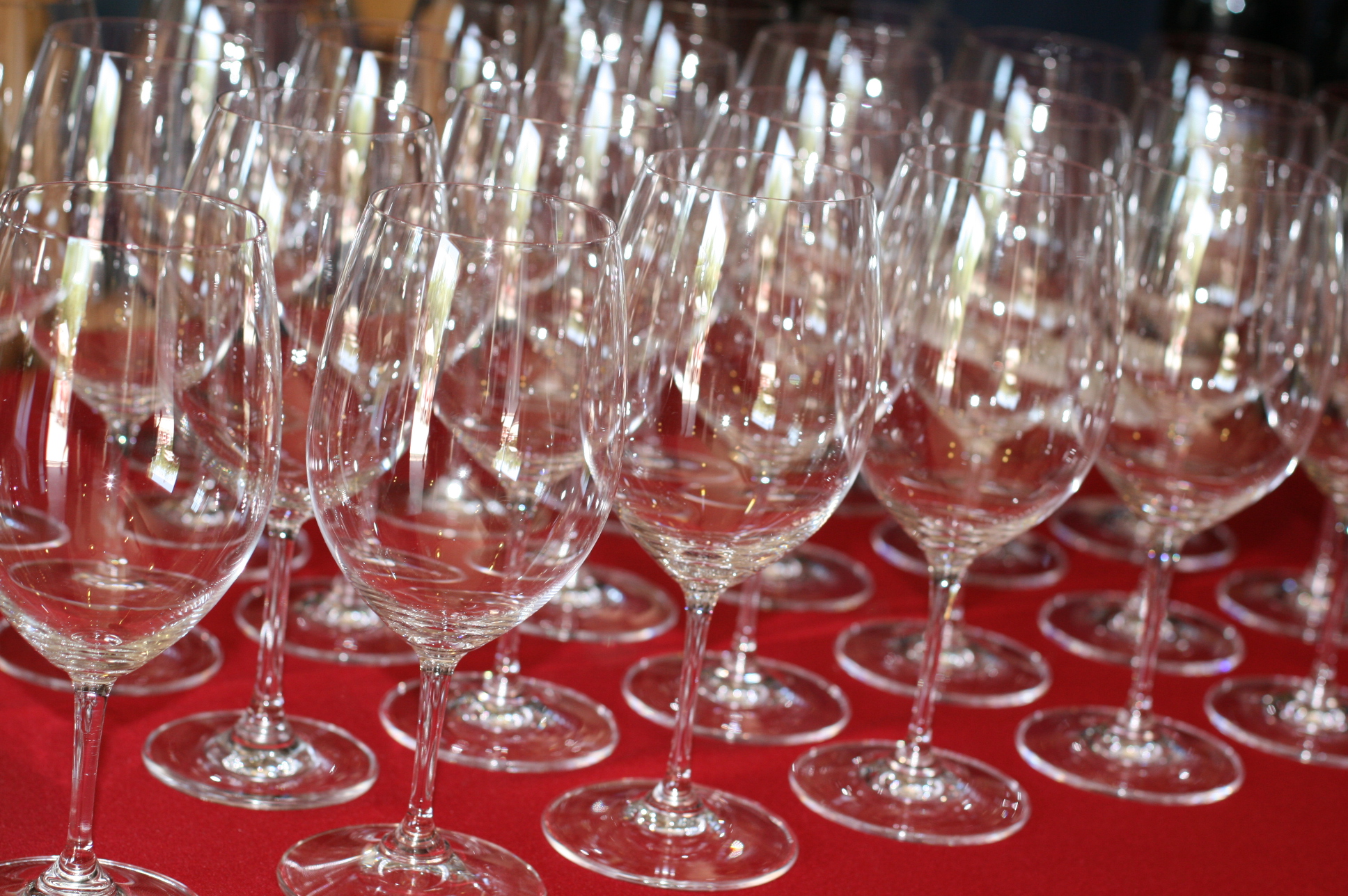 rows of wine glasses and champagne flutes on a red table