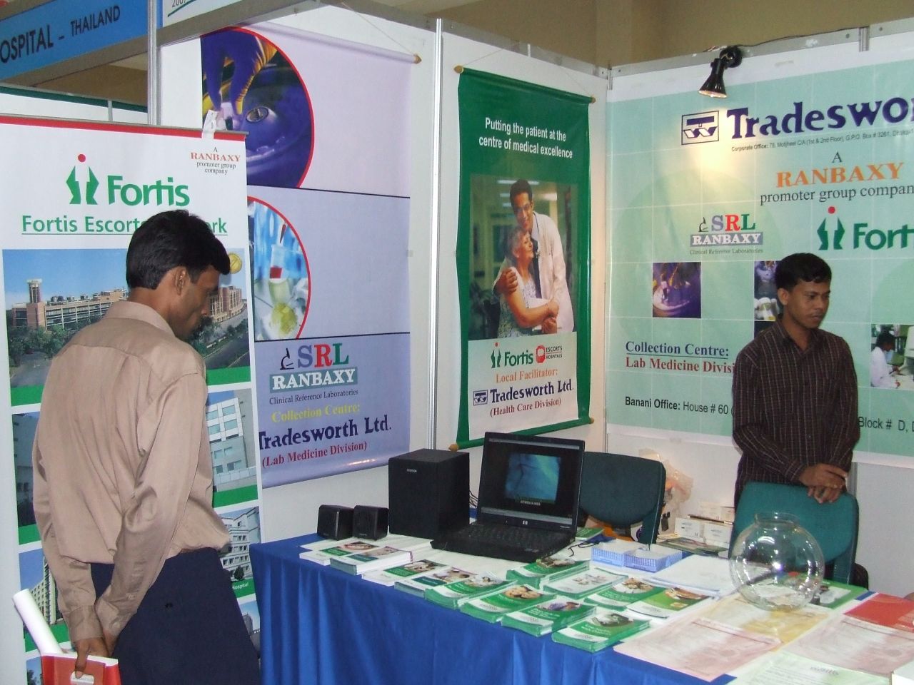 people are gathered around a booth for trade and information